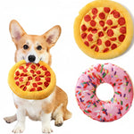 Dog holding a yellow pizza-shaped squeaky plush toy