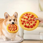 Dog playing with the pizza-shaped plush dog toy